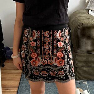 Black embroidered floral mini skirt with scalloped hem